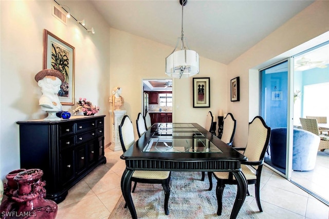 dining space with lofted ceiling, light tile patterned floors, a ceiling fan, and visible vents