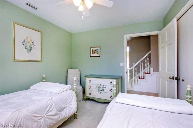 carpeted bedroom featuring visible vents and ceiling fan