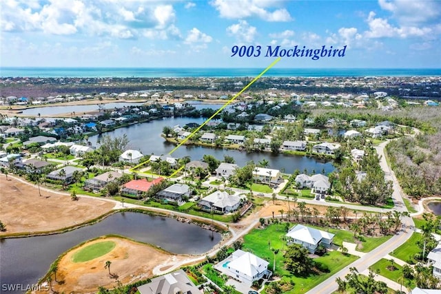 bird's eye view featuring a residential view and a water view