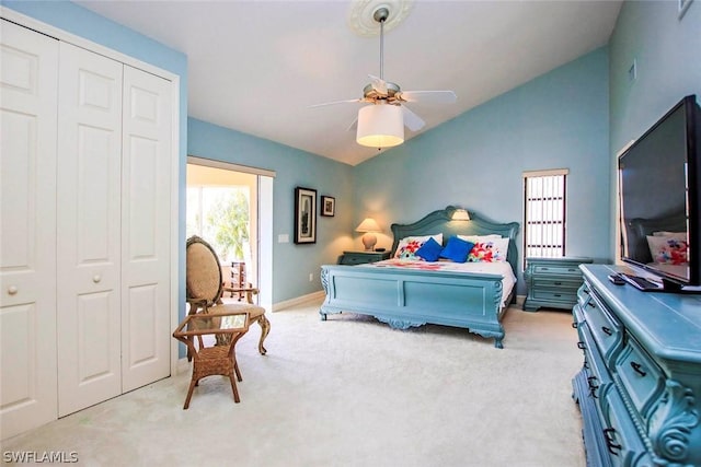 bedroom featuring a closet, carpet, ceiling fan, and vaulted ceiling