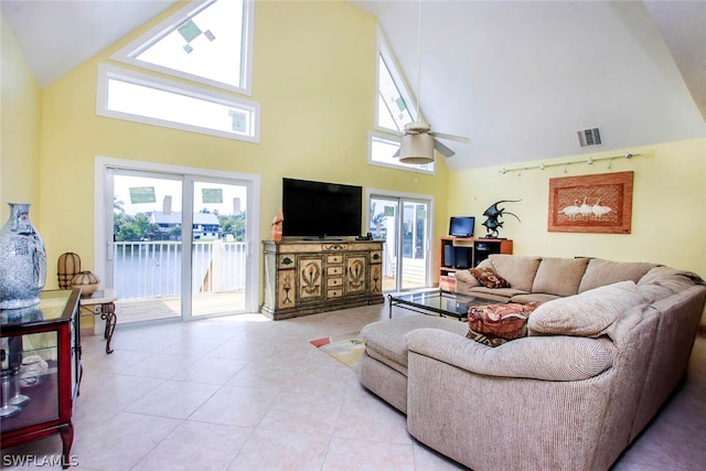 living room featuring tile patterned floors, visible vents, high vaulted ceiling, and a ceiling fan