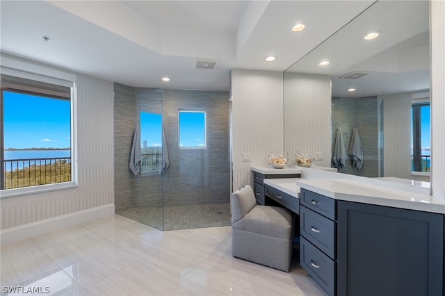 bathroom featuring vanity and tiled shower