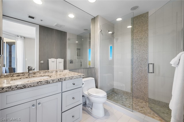 full bath featuring toilet, vanity, visible vents, tile patterned floors, and a stall shower