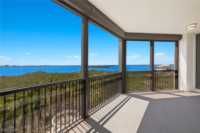 unfurnished sunroom featuring a water view