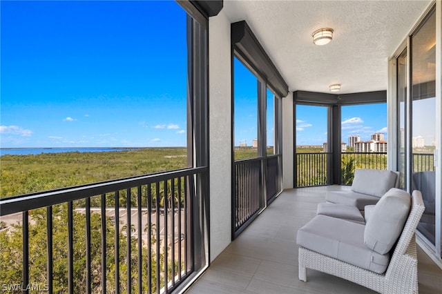 sunroom / solarium featuring a water view