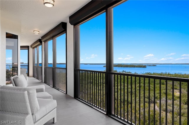 unfurnished sunroom with a water view