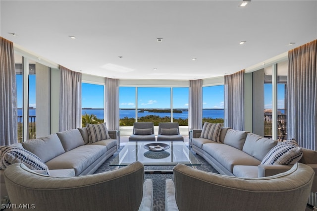 living room featuring plenty of natural light and a water view