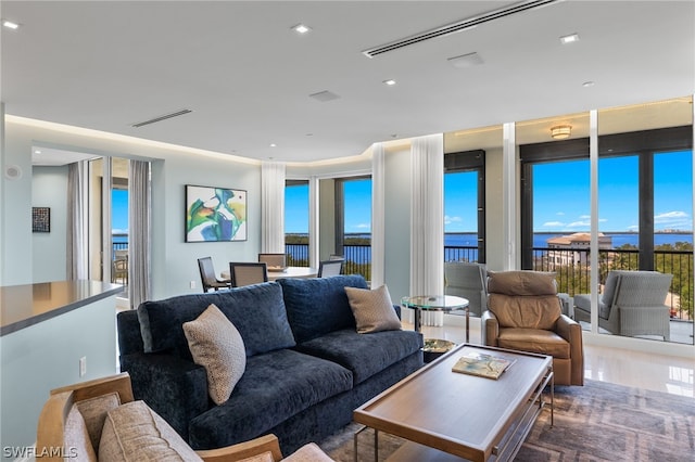 living room with wood-type flooring and a water view