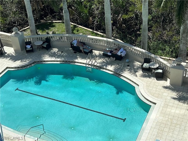 view of swimming pool featuring a patio area