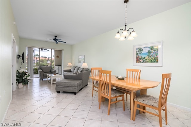 tiled dining area featuring ceiling fan with notable chandelier