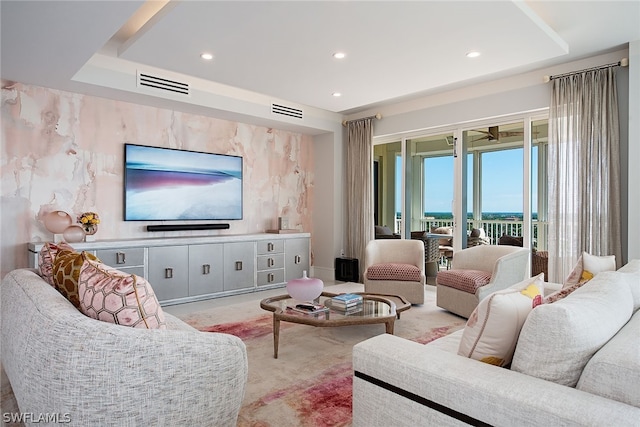 carpeted living room featuring a raised ceiling