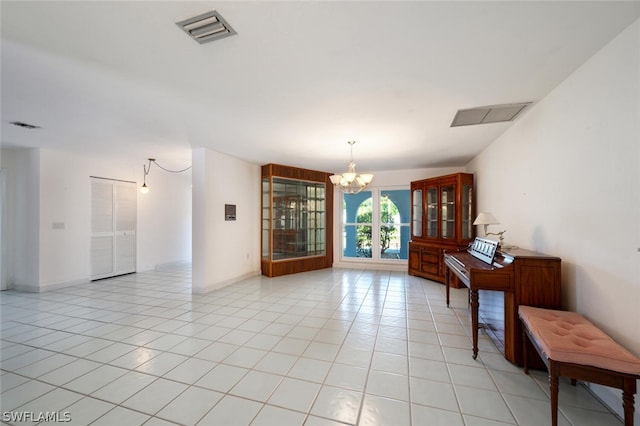 interior space with a chandelier and light tile flooring