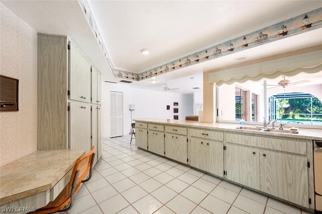 kitchen with ceiling fan, sink, and light tile floors