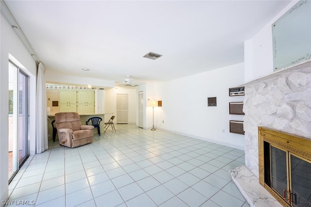 interior space with ceiling fan and a fireplace