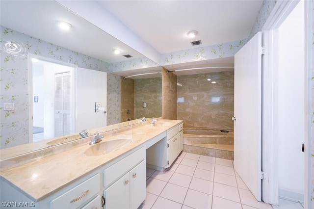 bathroom with tile floors, dual sinks, and vanity with extensive cabinet space