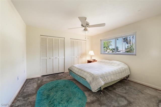 bedroom with ceiling fan and two closets