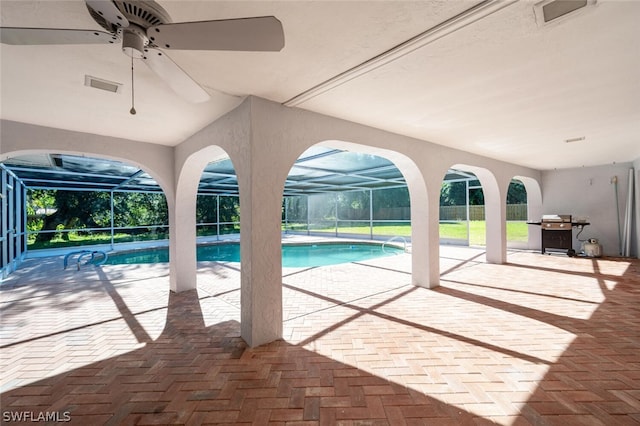 view of pool featuring ceiling fan, area for grilling, a patio area, and a lanai