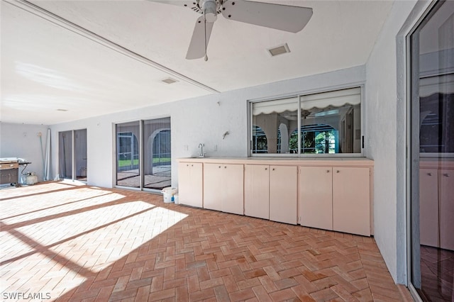 interior space with ceiling fan and sink