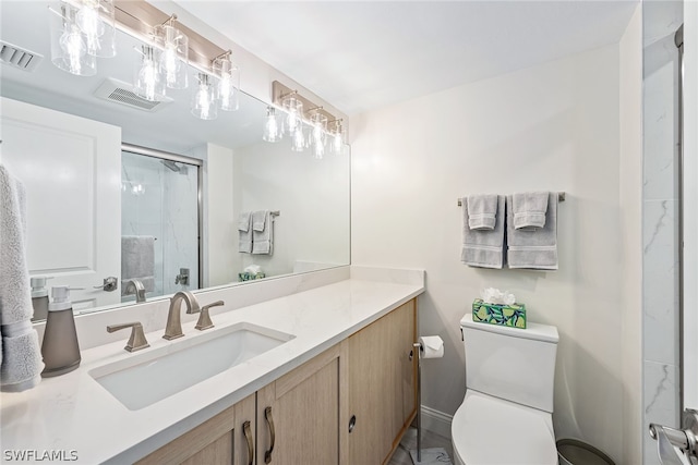 bathroom featuring large vanity and toilet