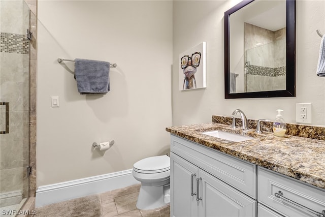 bathroom featuring vanity, toilet, tile patterned flooring, and an enclosed shower