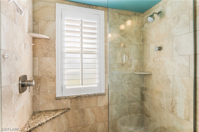 bathroom featuring plenty of natural light and a tile shower