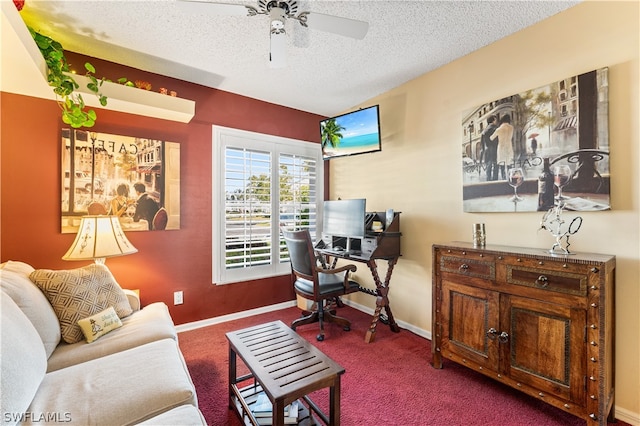 home office featuring carpet floors, a textured ceiling, and ceiling fan