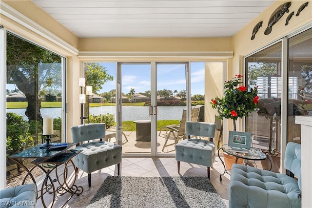 sunroom / solarium featuring a water view