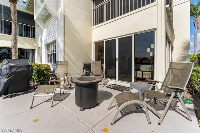 view of patio / terrace with an outdoor fire pit and a grill