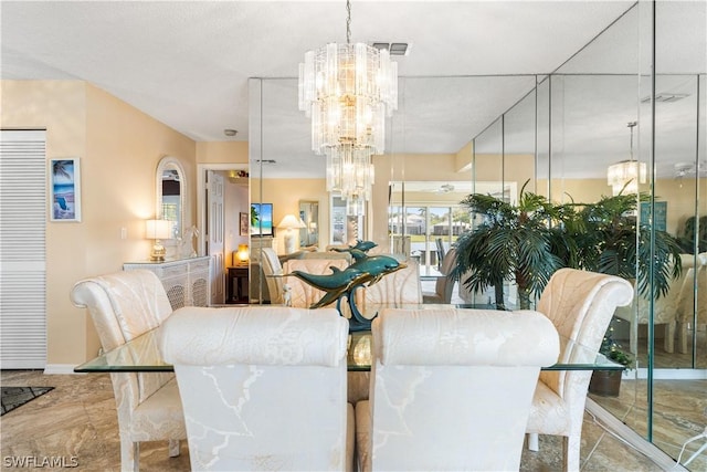 dining space featuring visible vents, baseboards, and an inviting chandelier