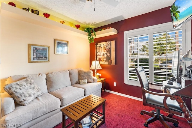 office space featuring a textured ceiling, carpet floors, ceiling fan, and baseboards