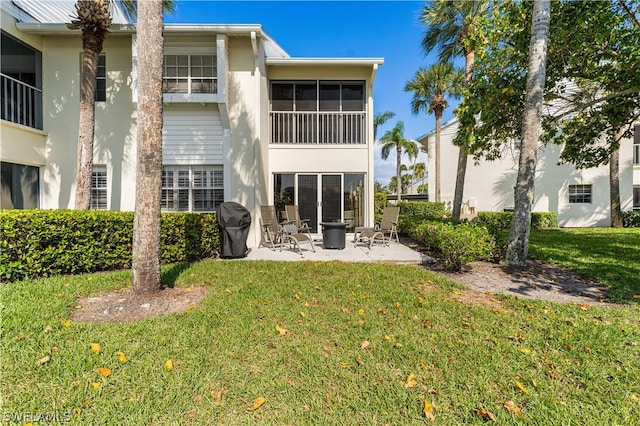 back of house with a patio and a yard