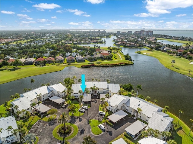 bird's eye view with a residential view, view of golf course, and a water view