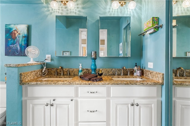 bathroom featuring toilet and vanity