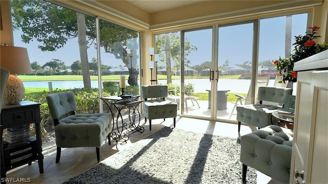 sunroom / solarium with a water view