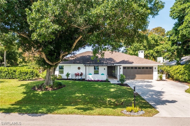 single story home with a garage, driveway, a front lawn, and stucco siding