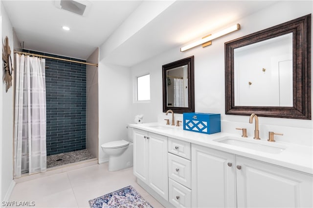 full bath featuring double vanity, a shower stall, toilet, and a sink