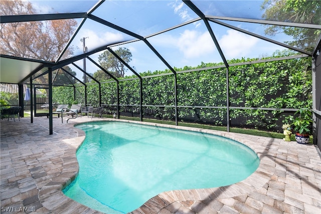 pool featuring a lanai and a patio area