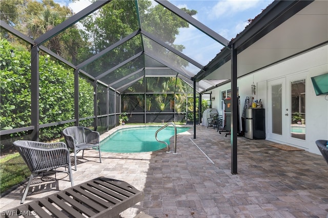 outdoor pool with french doors, water heater, a patio, and a lanai