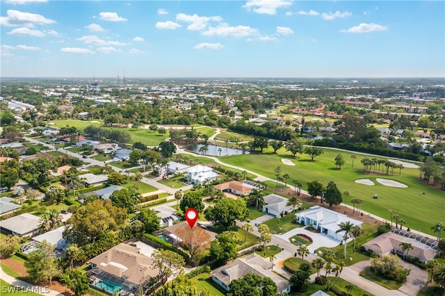 birds eye view of property with golf course view, a water view, and a residential view