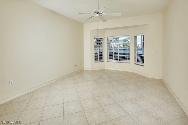 tiled empty room with ceiling fan