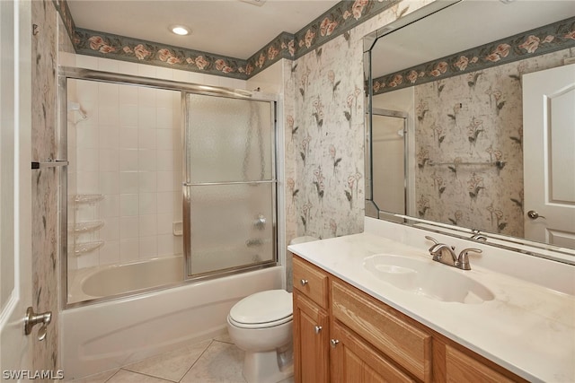 full bathroom with tile floors, combined bath / shower with glass door, toilet, and vanity