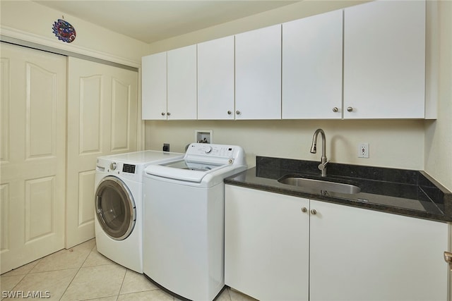 clothes washing area with hookup for an electric dryer, sink, light tile flooring, cabinets, and washing machine and dryer