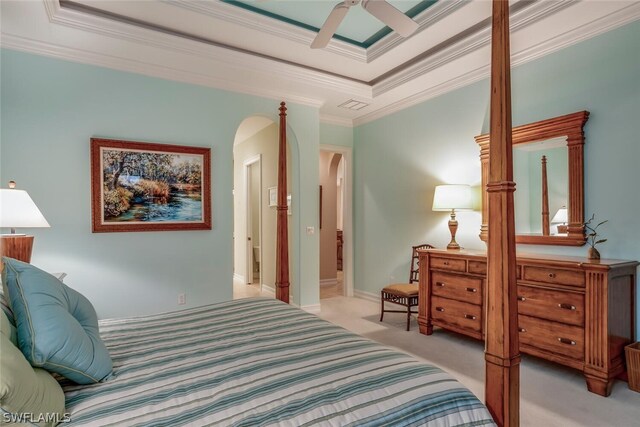 bedroom with ornamental molding, light colored carpet, a raised ceiling, and ceiling fan