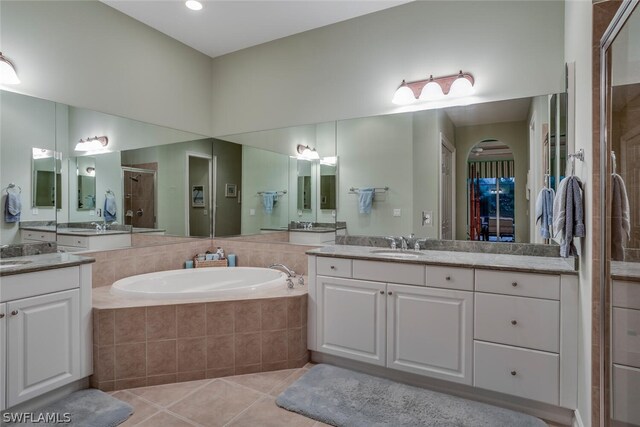 bathroom featuring vanity, separate shower and tub, and tile patterned floors