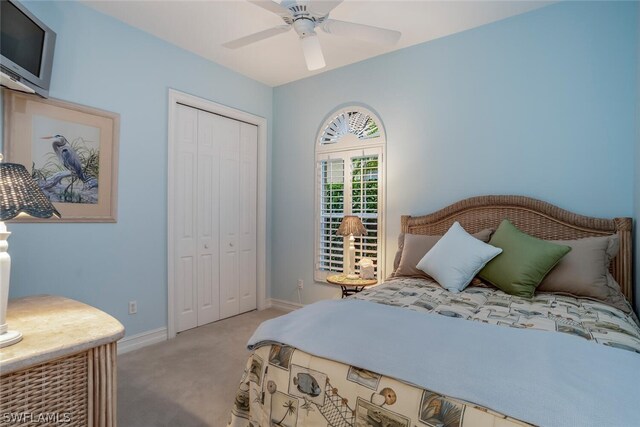 carpeted bedroom with a closet and ceiling fan