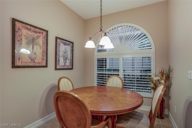 dining area with a notable chandelier and light tile patterned floors