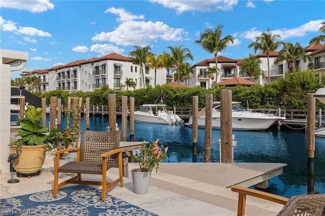 view of swimming pool featuring a dock and a water view