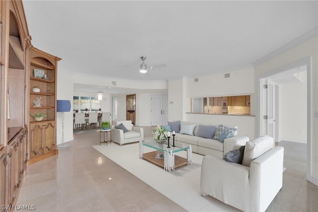 tiled living room featuring ornamental molding and ceiling fan