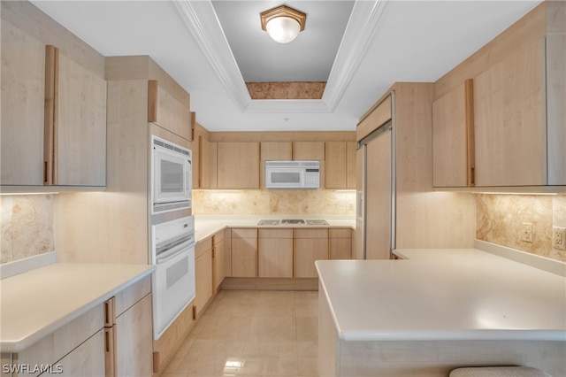 kitchen with light brown cabinets, light tile floors, white appliances, backsplash, and a raised ceiling