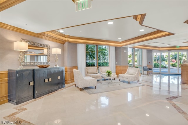 tiled living room with a raised ceiling and crown molding